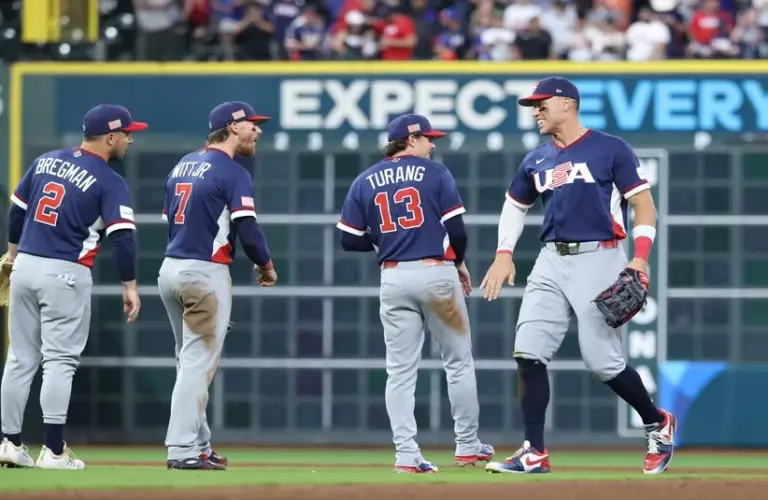 USA right fielder Aaron Judge (99), second baseman Brice Turang (13), shortstop Bobby Witt Jr. (7) and third baseman Alex Bregman (2) celebrate