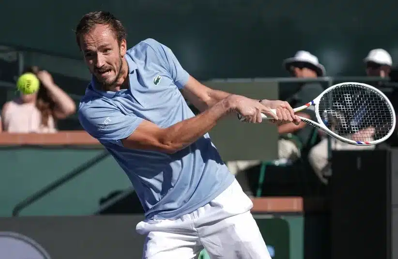 Daniil Medvedev hits a shot against Carlos Alcaraz