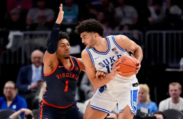 Virginia Cavaliers guard Malik Thomas (1) defends Duke Blue Devils forward Cameron Boozer (12) during the men's ACC Conference Tournament Championship.