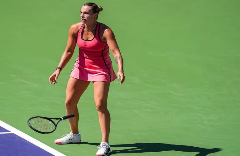 Aryna Sabalenka has her racket fall to the floor