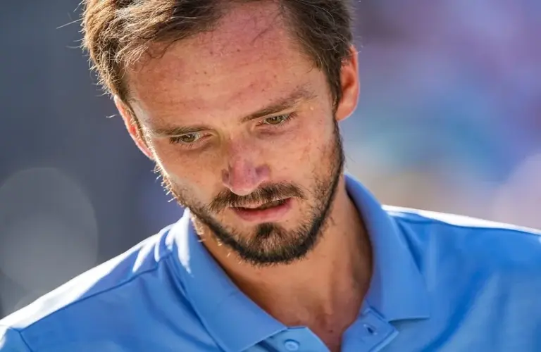 Medvedev looking at his racket