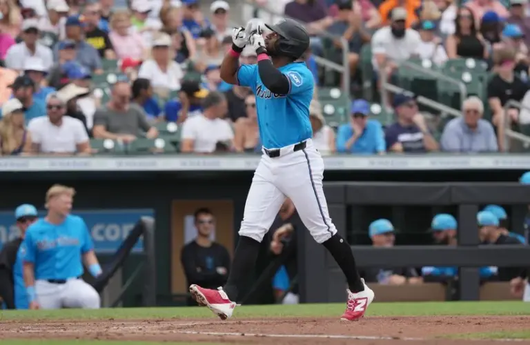 Miami Marlins shortstop Otto Lopez (6) looks to the sky as he crosses home plate