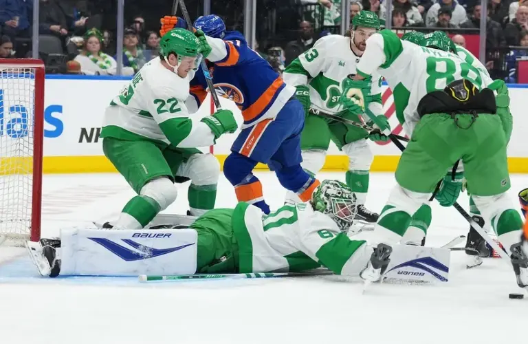New York Islanders left wing Emil Heineman (51) battles with Toronto Maple Leafs defenseman Jake McCabe (22) in front of goaltender Joseph Woll (60)