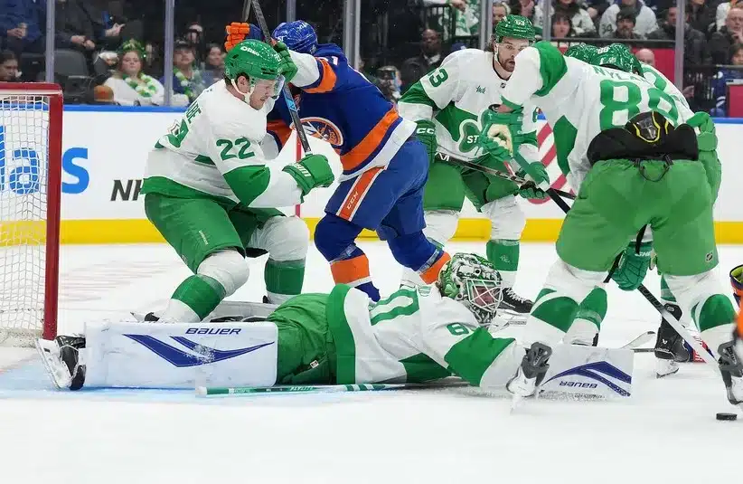 New York Islanders left wing Emil Heineman (51) battles with Toronto Maple Leafs defenseman Jake McCabe (22) in front of goaltender Joseph Woll (60)