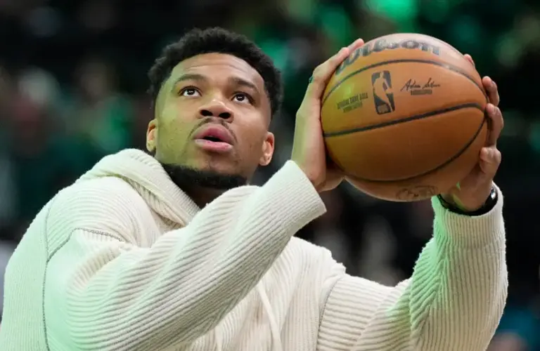 Giannis Antetokounmpo (34) takes shots during a timeout against the Cleveland Cavaliers in the first half at Fiserv Forum.