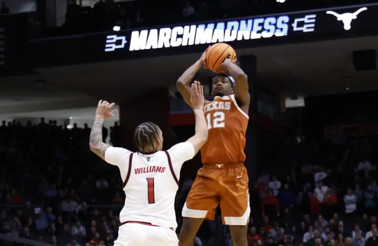 Texas player taking a shot in NCAA Tournament.