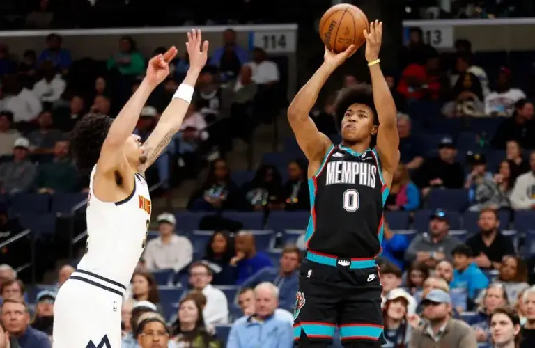 Memphis Grizzlies forward Jaylen Wells (0) shoots as Denver Nuggets guard Julian Strawther (3) defends during the second quarter.