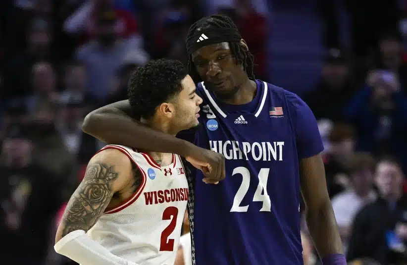 High Point player embracing a Wisconsin player after game.