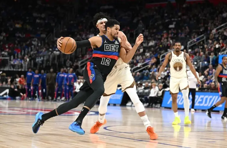 Detroit Pistons forward Tobias Harris (12) drives past Golden State Warriors forward Gui Santos (15)