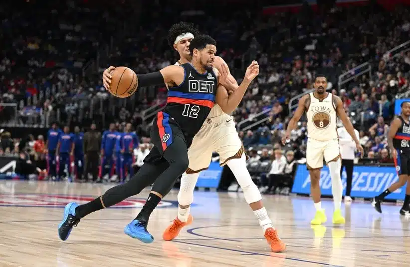 Detroit Pistons forward Tobias Harris (12) drives past Golden State Warriors forward Gui Santos (15)