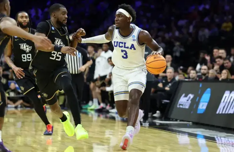 UCLA Bruins forward Eric Dailey Jr. (3) dribbles the ball against the UCF Knights in the second half during a first round game of the men's 2026 NCAA Tournament.