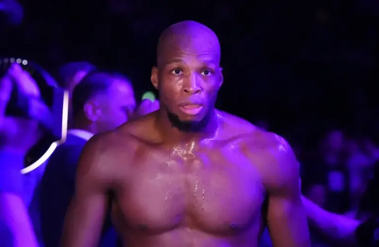 Michael Page (red gloves) leaves the arena after the fight against Sam Patterson