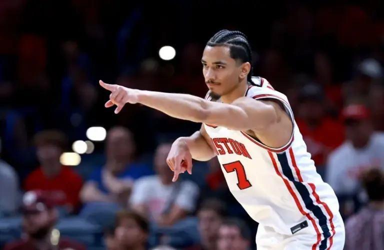Houston's Milos Uzan (7) celebrates a 3-point basket during a second-round game in the NCAA men's basketball tournament