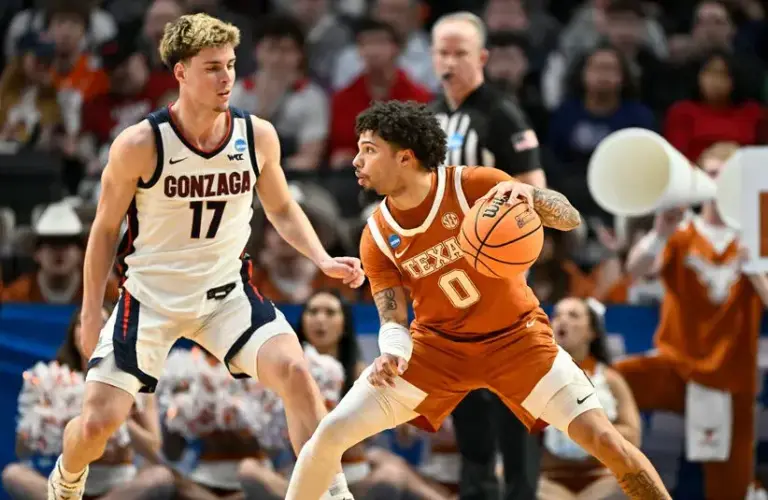Texas Longhorns guard Jordan Pope (0) dribbles against Gonzaga Bulldogs guard Mario Saint-Supery (17) in the second half during a second round game of the men's 2026 NCAA Tournament.
