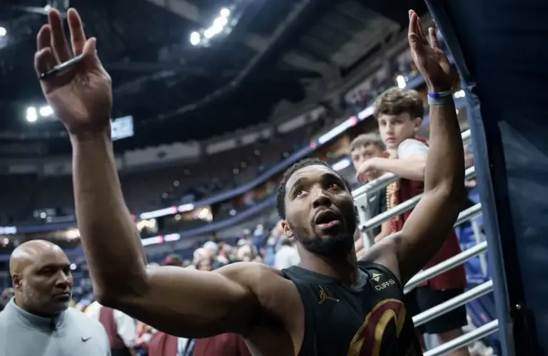 Cleveland Cavaliers guard Donovan Mitchell (45), high fives fans.