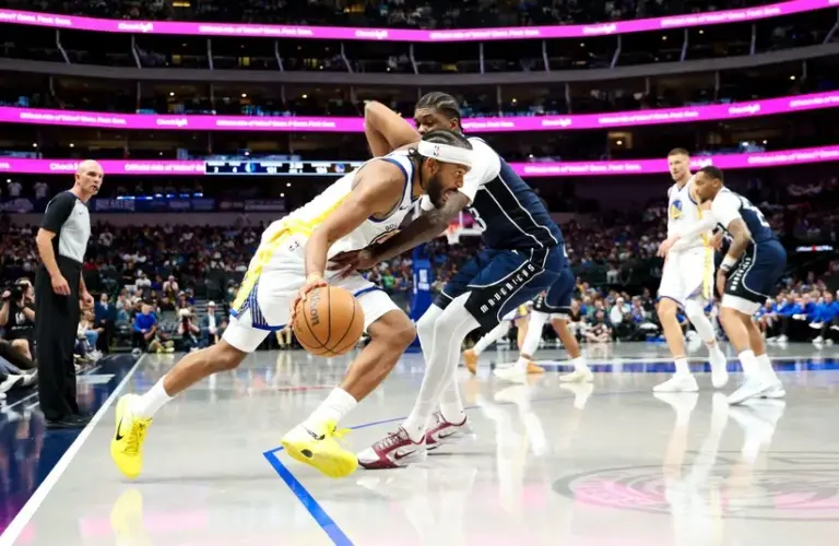 Golden State Warriors guard Moses Moody (4) drives to the basket as Dallas Mavericks forward Naji Marshall (13) defends