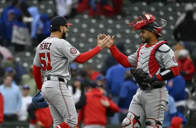 Washington Nationals pitcher Cionel Perez(51) and catcher Keibert Ruiz (20) celebrate after a game