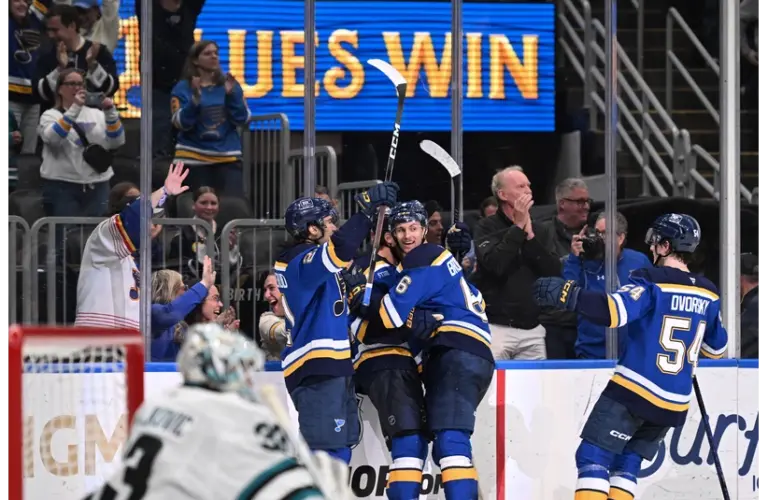 Blues on the ice celebrating the overtime winning goal
