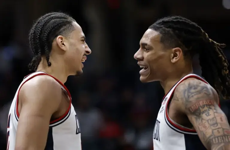 UConn Huskies forward Jayden Ross (23) and guard Solo Ball (1) react