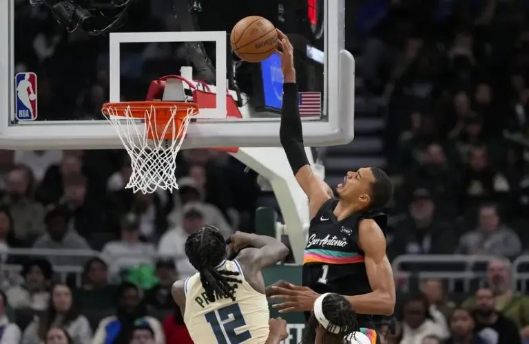 San Antonio Spurs forward Victor Wembanyama (1) shoots over Milwaukee Bucks forward Taurean Prince (12).