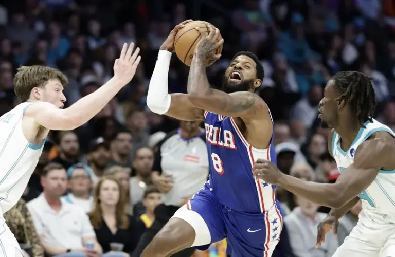 Philadelphia 76ers forward Paul George (8) tries to drive.