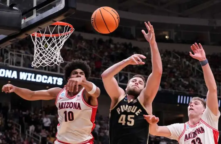 Purdue and Arizona players going for a rebound in the NCAA Tournament.