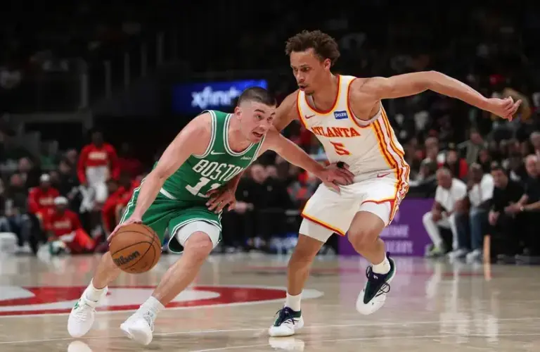 Boston Celtics guard Payton Pritchard (11) dribbles against Atlanta Hawks guard Dyson Daniels (5) in the first half.