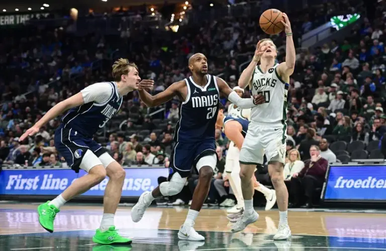 Milwaukee Bucks guard AJ Green (20) takes a shot against Dallas Mavericks forward Khris Middleton (20)