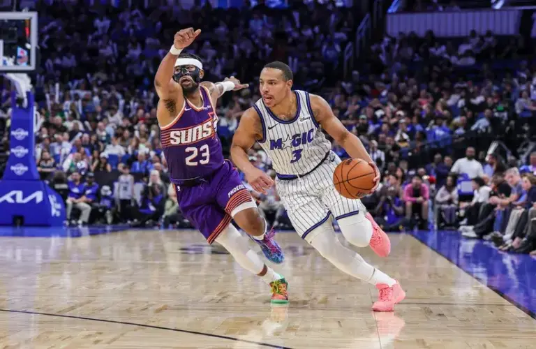 Orlando Magic guard Desmond Bane (3) drives around Phoenix Suns guard Jordan Goodwin (23) during the second half at Kia Center.
