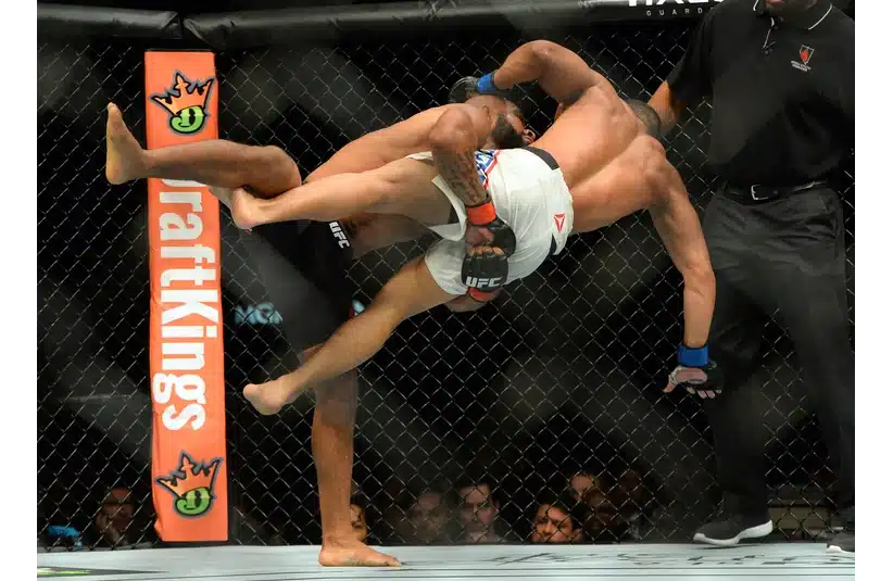 Demetrious Johnson (red gloves) and John Dodson (blue gloves) during their flyweight title bout at UFC 191