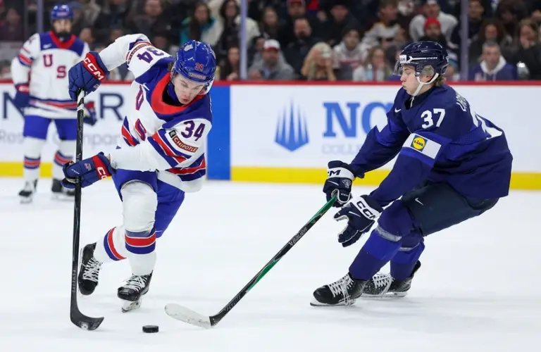 Jan 2, 2026; St. Paul, Minnesota, UNITED STATES; United States forward Cole Eiserman (34) and Finland forward Matias Vanhanen (37) compete for the puck during the first period in the quarterfinals of the 2026 IIHF World Junior Championship at Grand Casino Arena.