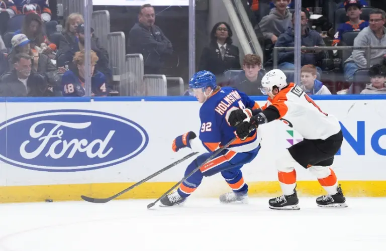 Apr 3, 2026; Elmont, New York, USA; Philadelphia Flyers forward Travis Konecny (11) defends against New York Islanders forward Simon Holmstrom (92) in the third period at UBS Arena.