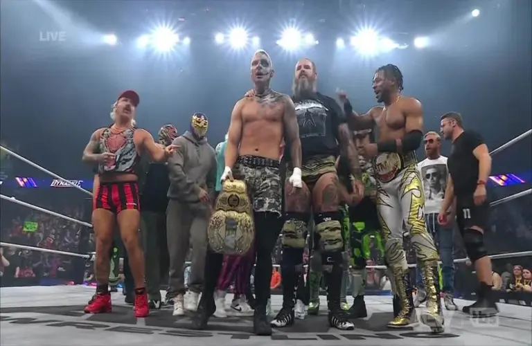 Darby Allin celebrating with the AEW locker room after beating MJF.