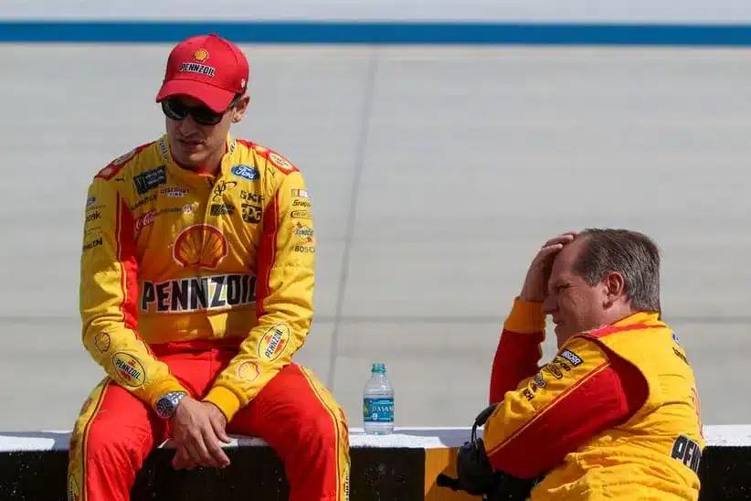 Oct 1, 2017; Dover, DE, USA; NASCAR Cup Series driver Joey Logano (left) sits on the pit road wall as his crew chief Todd Gordon (right) looks on prior to the Apache Warrior 400 at Dover International Speedway.