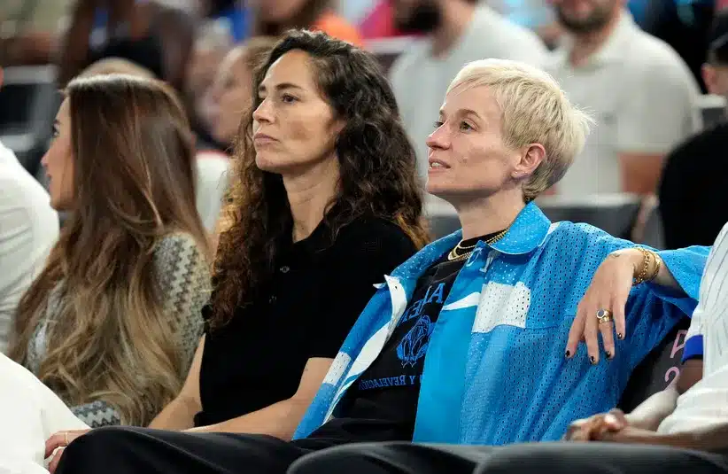 Sue Bird and Megan Rapinoe look on during the first half between France and Germany in a men's basketball semifinal game during the Paris 2024 Olympic Summer Games at Accor Arena