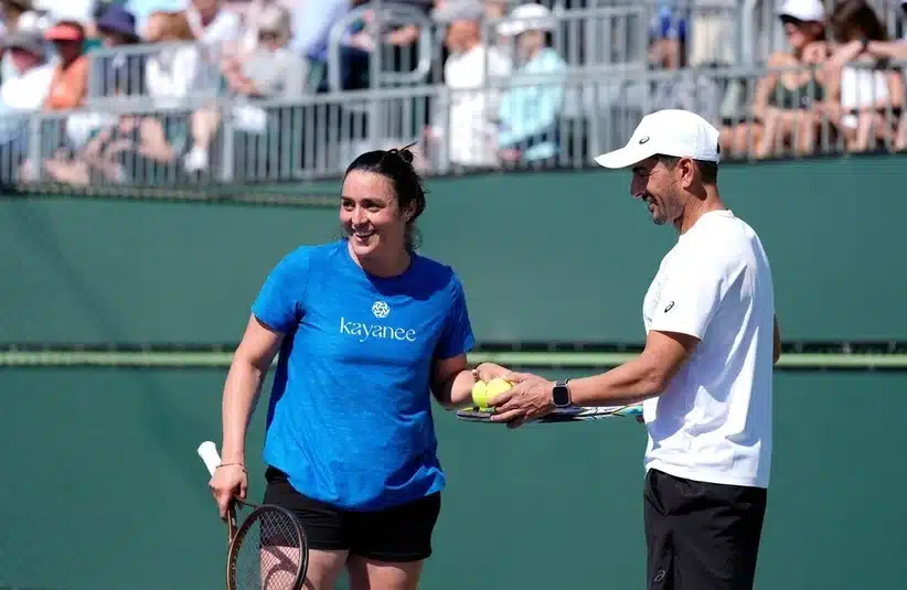 Jabeur taking the tennis balls from coach