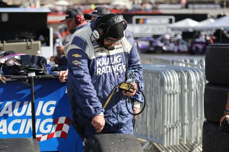 Caption: Apr 13, 2025; Bristol, Tennessee, USA; A Kaulig Racing crew member checks Goodyear tires after a run during the NASCAR Food City 500 at Bristol Motor Speedway.