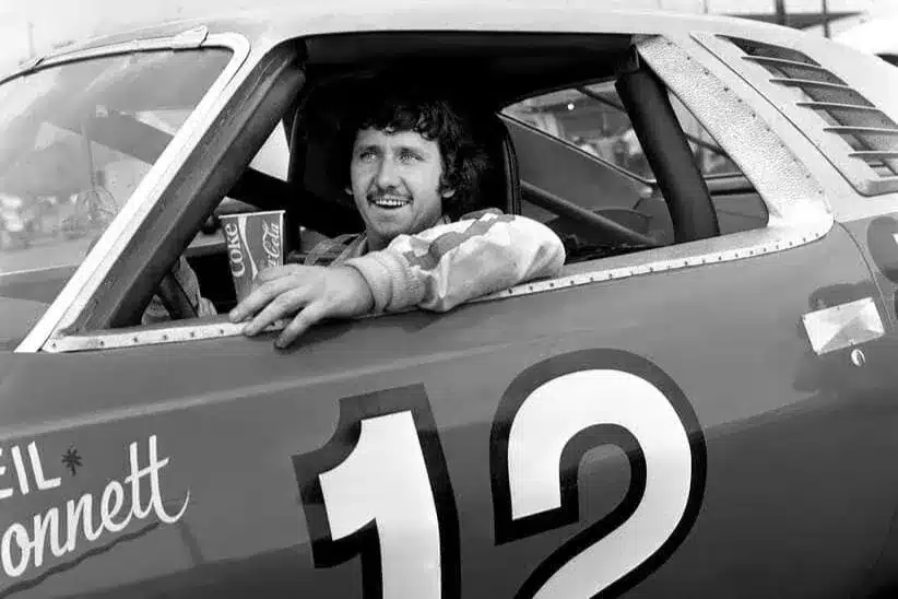 Driver Neil Bonnett of Hueytown, Ala., waits for the start of the Nashville 420 Grand National race at the Nashville Speedway on July 19, 1975. But rain postponed the race to the next day.