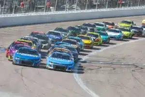 May 11, 2025; Kansas City, Kansas, USA; NASCAR Cup Series drivers Chase Elliott (9) and Kyle Larson (5) lead the pack during a restart at the AdventHealth 400 at Kansas Speedway.