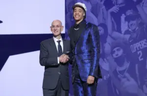 Yanic Konan Niederhauser stands with NBA commissioner Adam Silver after being selected as the 30th pick by the Los Angeles Clippers in the first round of the 2025 NBA Draft.