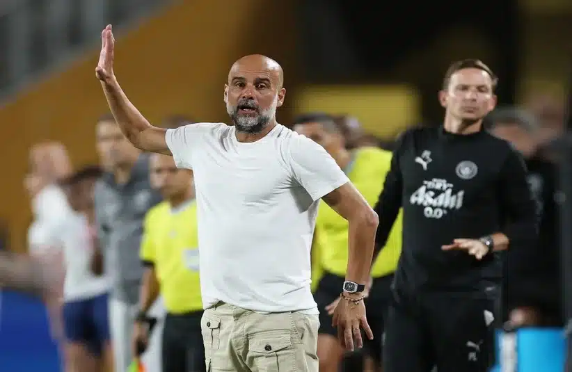 Pep Guardiola waving instructions from the dugout