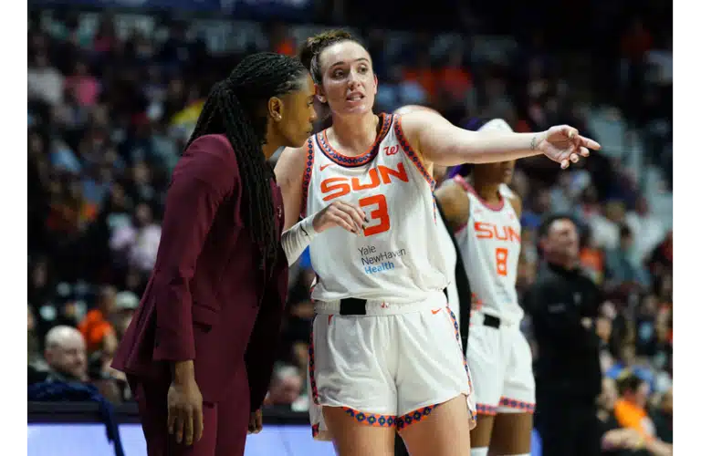 Marina Mabrey talking with one of her coaches during a game last season.