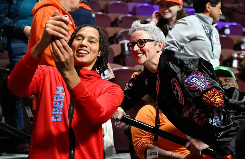 Atlanta Dream center Brittney Griner takes a selfie with a fan before a game against the Connecticut Sun at Mohegan Sun Arena. 