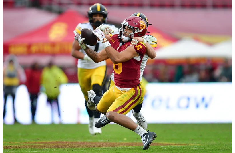 Makai Lemon (6) catches a pass against the defense of Iowa Hawkeyes