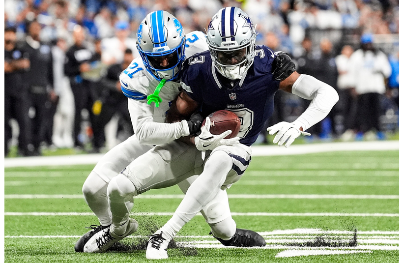 Dec 4, 2025; Detroit, Michigan, USA; Detroit Lions cornerback Amik Robertson (21) tackles Dallas Cowboys wide receiver George Pickens (3) during the first half at Ford Field. Mandatory Credit: Junfu Han-USA TODAY Network via Imagn Images