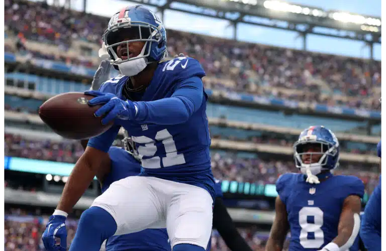 Giants Paulson Adebo jumping on the field