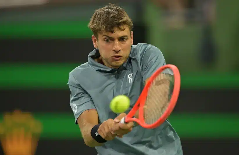 Cobolli hitting a backhand shot