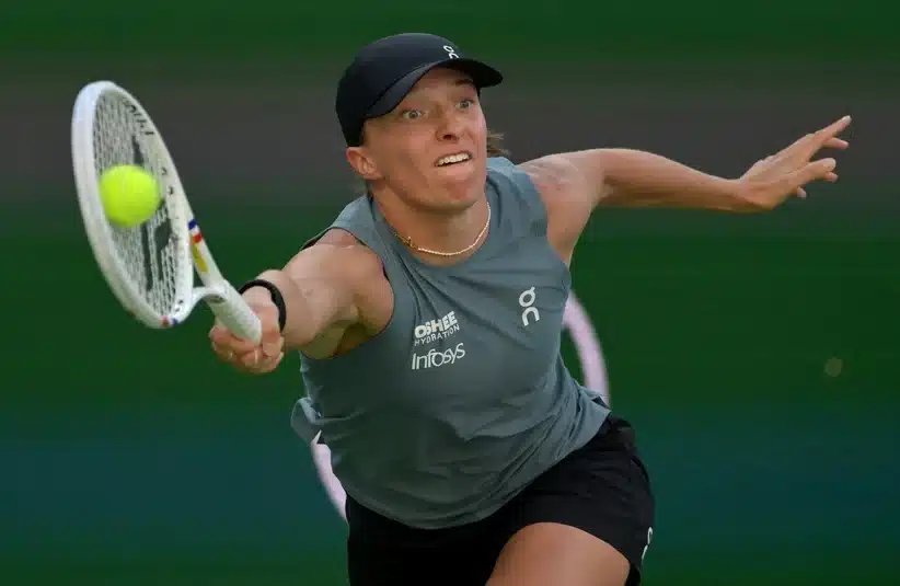 Swiatek hitting a forehand return