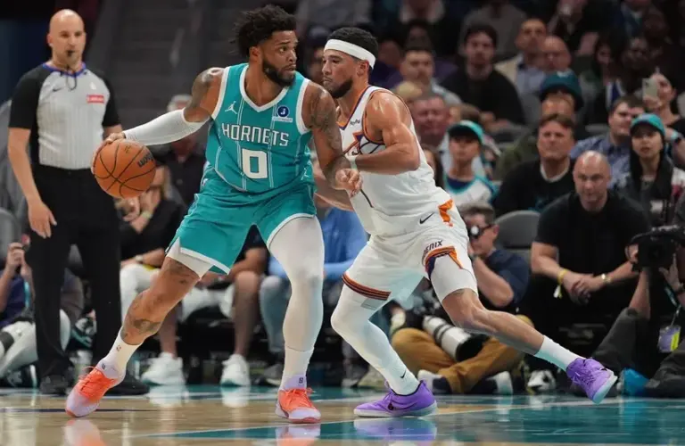 Charlotte Hornets forward Miles Bridges (0) works the ball.