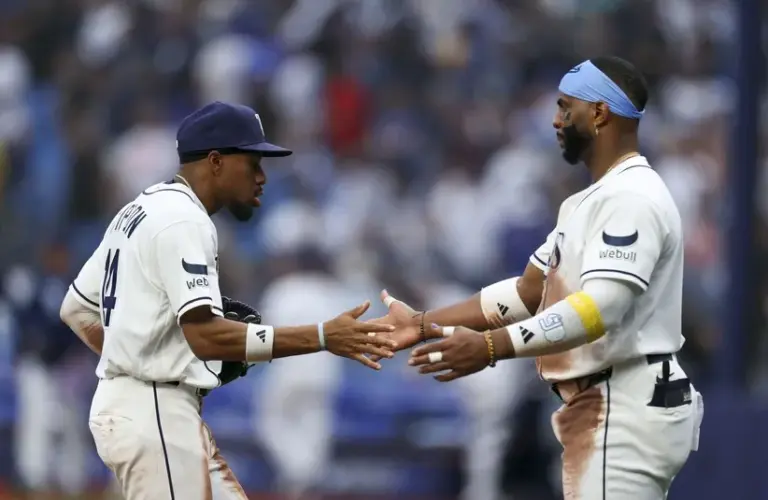 Tampa Bay Rays center fielder Chandler Simpson (14) and designated hitter Yandy Diaz (2) react after beating the Chicago Cubs.